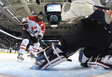 GRAND FORKS, NORTH DAKOTA - APRIL 24: USA get the puck past Canada's Stuart Skinner #30 for a first period goal while Canada's Jakob Chychrun #5 looks on during bronze medal game action at the 2016 IIHF Ice Hockey U18 World Championship. (Photo by Matt Zambonin/HHOF-IIHF Images)

